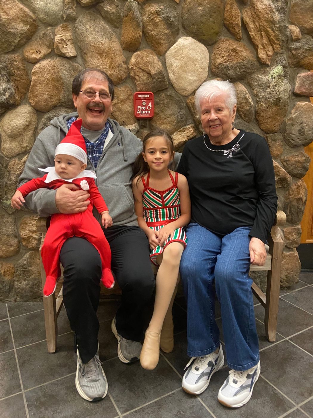 Jerilyn with family in front of a stone wall