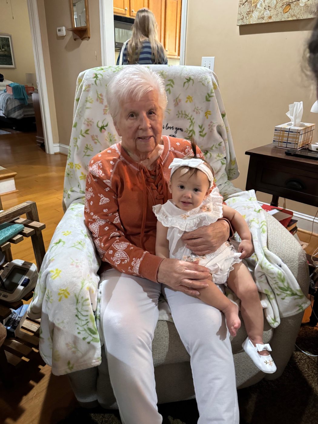Jerilyn sitting with a young family member
