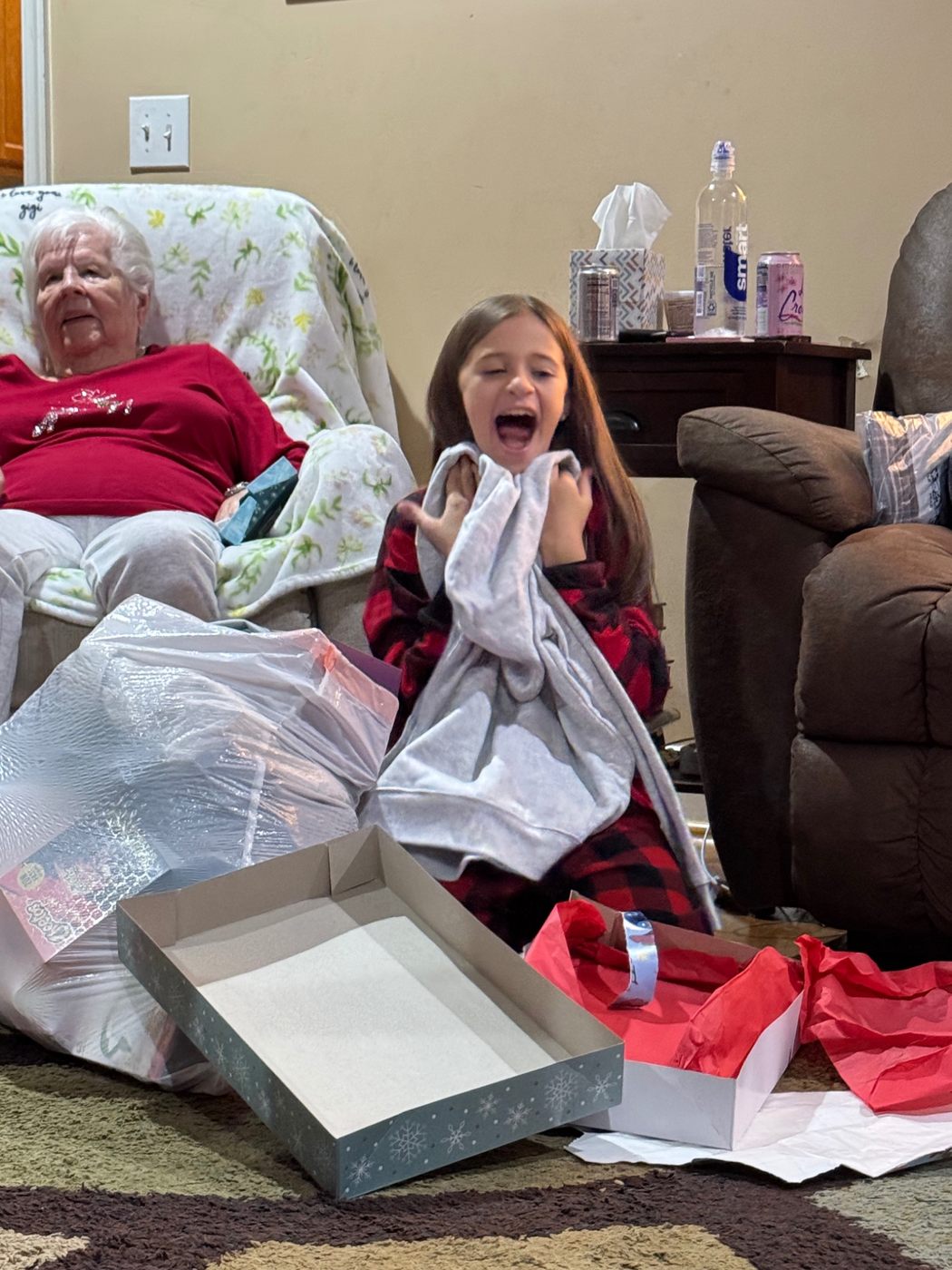 Jerilyn watching a child open a holiday gift