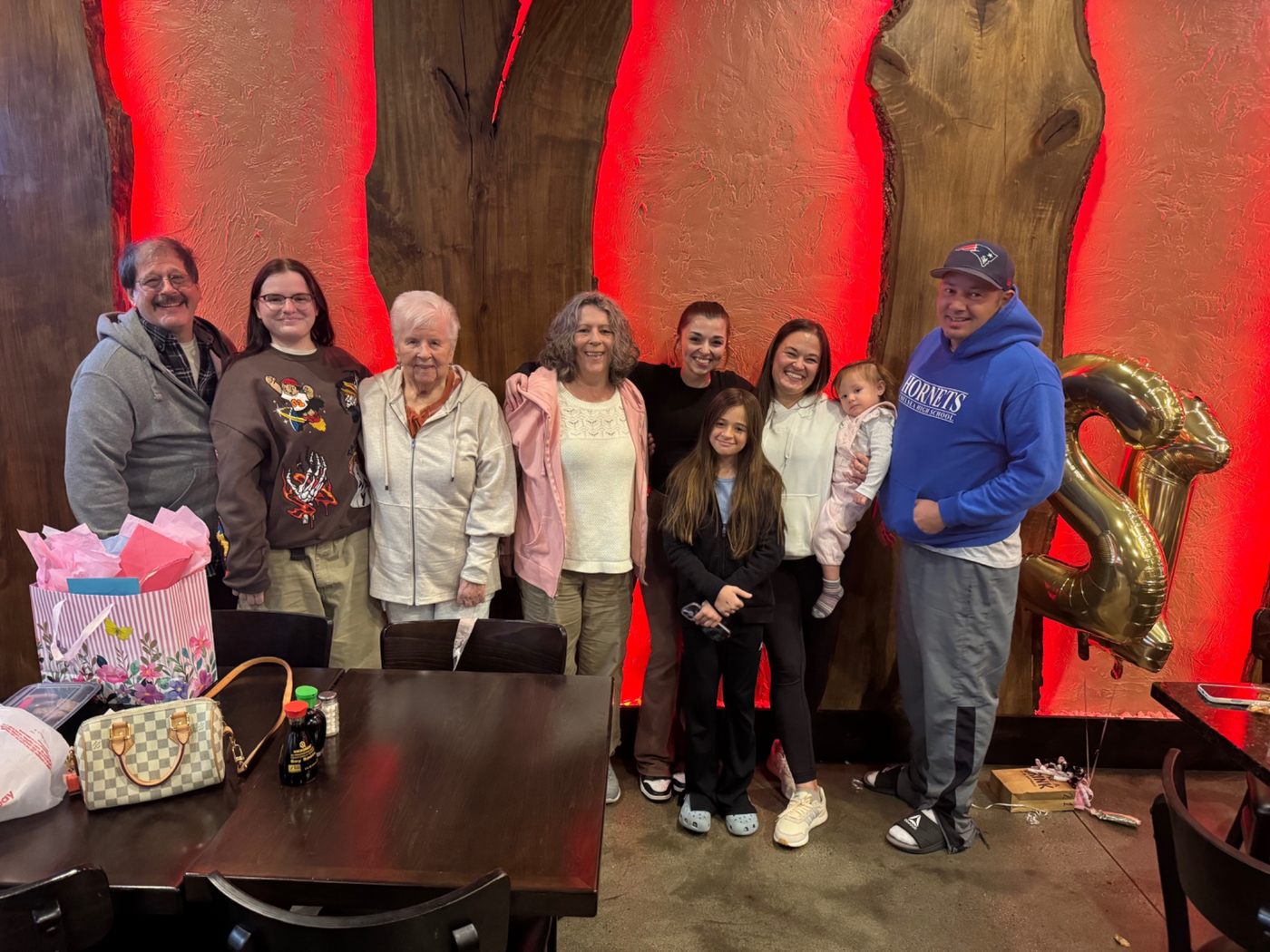 Jerilyn standing with family at a birthday celebration